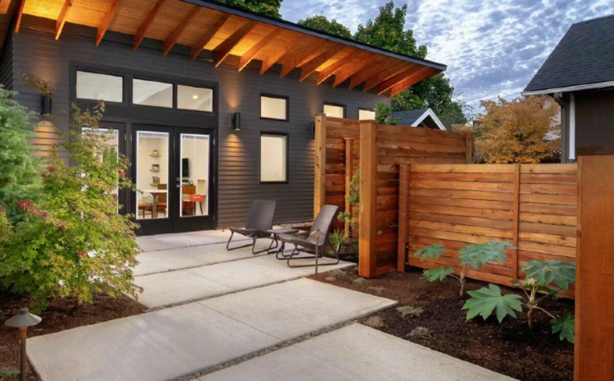 Modern backyard ADU with warm wood roof overhang