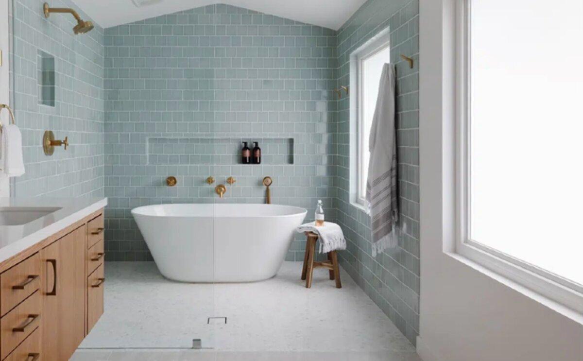 Renovated bathroom with freestanding tub and sage-green tile