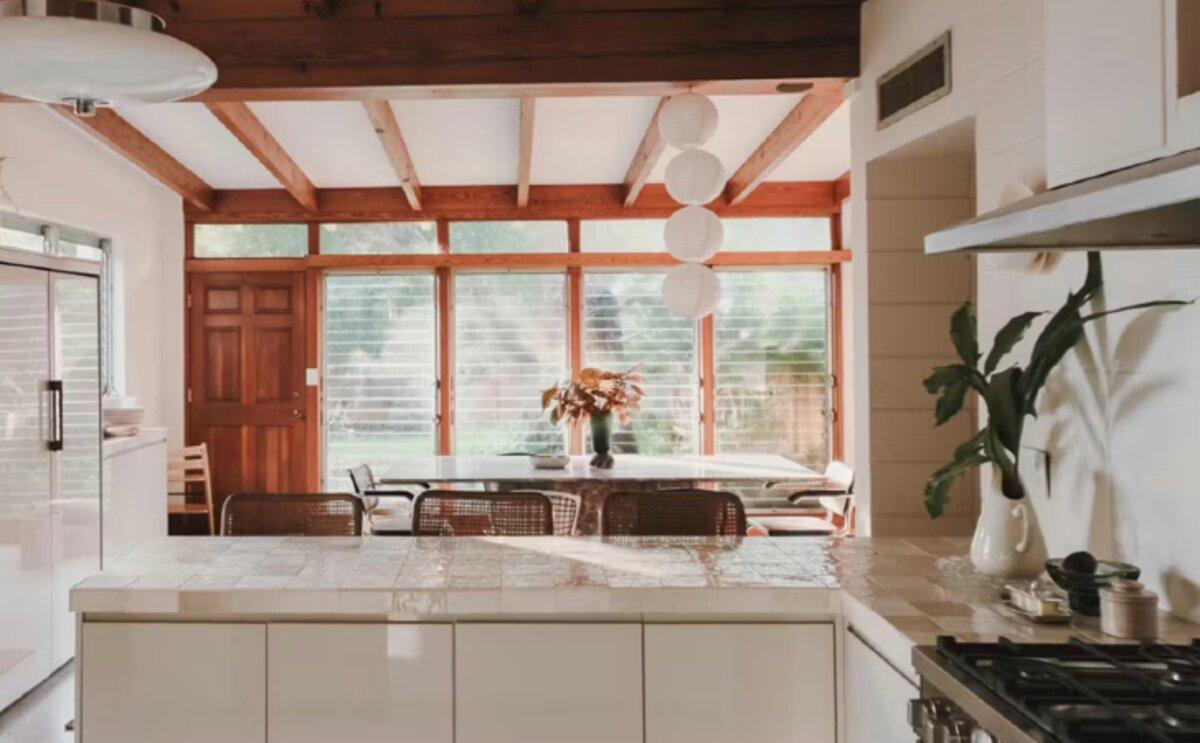 Remodeled kitchen with exposed wood beams and natural light